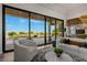 Bright living room features stylish furniture and large windows with beautiful outdoor views at 2548 Faiss Dr, Las Vegas, NV 89134