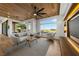Inviting living area with modern furniture, statement ceiling fan, and picturesque outdoor views at 2548 Faiss Dr, Las Vegas, NV 89134