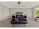 Staged primary bedroom featuring a tufted headboard, chandelier, and bench at 2548 Faiss Dr, Las Vegas, NV 89134