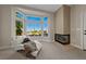 Inviting sitting area with a cozy fireplace, bay window, and comfortable seating at 2548 Faiss Dr, Las Vegas, NV 89134