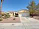 Charming single-story home featuring a well-manicured lawn, mature trees, and a spacious two-car garage at 2558 Grandville Ave, Henderson, NV 89052