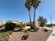 Inviting single-story home featuring mature landscaping and palm trees in a well-maintained yard at 2558 Grandville Ave, Henderson, NV 89052