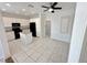 Modern kitchen with white cabinetry, tile floors, black appliances, and a central island provides ample space at 2558 Grandville Ave, Henderson, NV 89052