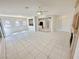 Spacious living area with tile floors, ceiling fan, and open layout to kitchen and dining at 2558 Grandville Ave, Henderson, NV 89052