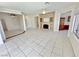 Open-concept living space with tiled flooring, fireplace feature, and neutral decor at 2558 Grandville Ave, Henderson, NV 89052