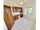 This office features built-in wooden cabinets, drawers, a desk, tile flooring, and natural light from the window at 2558 Grandville Ave, Henderson, NV 89052