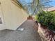 Narrow side yard with gravel, shrubs, and gate along fence at 2558 Grandville Ave, Henderson, NV 89052