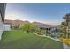 Beautiful backyard with artificial turf, landscaping, and mountain views at 26 Sun Mirage Ave, Henderson, NV 89011