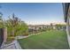 Lush backyard featuring an manicured lawn, colorful flowerbeds, and a privacy fence at 26 Sun Mirage Ave, Henderson, NV 89011