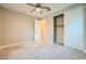 Bedroom with neutral walls, carpet floors, ceiling fan, and sliding door closet at 26 Sun Mirage Ave, Henderson, NV 89011
