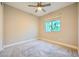 Bright bedroom with neutral walls, carpet, ceiling fan, and a window at 26 Sun Mirage Ave, Henderson, NV 89011