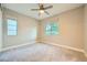 Bedroom with neutral walls, carpet floors, ceiling fan, and window at 26 Sun Mirage Ave, Henderson, NV 89011