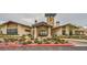 Well-maintained clubhouse exterior with stone accents, lush landscaping, and ample parking at 26 Sun Mirage Ave, Henderson, NV 89011
