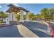 Welcoming community entrance featuring desert landscaping and a stone gate at 26 Sun Mirage Ave, Henderson, NV 89011