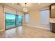 Dining area with sliding glass doors to backyard, modern light fixture and wood-look tile flooring at 26 Sun Mirage Ave, Henderson, NV 89011