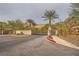 Gated community entrance with lush landscaping and a speed limit sign at 26 Sun Mirage Ave, Henderson, NV 89011