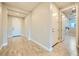 Bright entryway with wood-look tile flooring and a view of the white front door at 26 Sun Mirage Ave, Henderson, NV 89011