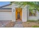 Inviting front entrance with stone steps, desert landscaping, and a two-car garage at 26 Sun Mirage Ave, Henderson, NV 89011