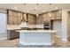 Bright kitchen boasts modern gray cabinets, stainless appliances, a large island and stylish pendant lighting at 26 Sun Mirage Ave, Henderson, NV 89011