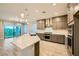 Modern kitchen featuring a kitchen island with a sink and stainless steel appliances at 26 Sun Mirage Ave, Henderson, NV 89011