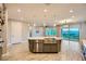Open-concept kitchen featuring a kitchen island with seating and stainless steel appliances at 26 Sun Mirage Ave, Henderson, NV 89011