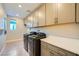 Bright laundry room featuring modern appliances and ample storage space with cabinets above the washer and dryer at 26 Sun Mirage Ave, Henderson, NV 89011