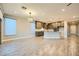 Open-concept living space with kitchen, living and dining areas, wood-look floors and modern lighting at 26 Sun Mirage Ave, Henderson, NV 89011
