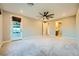 Large main bedroom with neutral carpet, fan, and exterior access to patio at 26 Sun Mirage Ave, Henderson, NV 89011