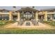 Elegant outdoor patio with fire pit, comfortable seating, and manicured landscaping at 26 Sun Mirage Ave, Henderson, NV 89011