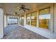 Covered patio with brick floor, ceiling fans, and views into the house at 26 Sun Mirage Ave, Henderson, NV 89011
