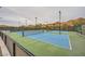 Community tennis courts featuring well-maintained surfaces, mountain views, and ample lighting at 26 Sun Mirage Ave, Henderson, NV 89011