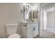 Bathroom features a modern vanity with marble counters and modern lighting at 2629 Blue Reef Dr, North Las Vegas, NV 89032