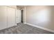 A bedroom features fresh gray carpet, closet and neutral colored walls at 2629 Blue Reef Dr, North Las Vegas, NV 89032