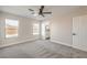 Light bedroom features carpet flooring, a ceiling fan, and an ensuite bathroom at 2629 Blue Reef Dr, North Las Vegas, NV 89032