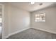 A bedroom features fresh gray carpet, a window letting in natural light, and neutral paint at 2629 Blue Reef Dr, North Las Vegas, NV 89032