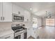 Stylish kitchen featuring white cabinetry, stainless steel appliances, and marble countertops at 2629 Blue Reef Dr, North Las Vegas, NV 89032