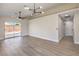 Spacious living room featuring wood-look flooring and sliding glass door access to the backyard at 2629 Blue Reef Dr, North Las Vegas, NV 89032