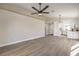 Open-concept living space featuring wood-look flooring and modern ceiling fan at 2629 Blue Reef Dr, North Las Vegas, NV 89032