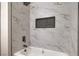 Updated shower and tub with white marble, gray accents, and updated shower head at 2629 Blue Reef Dr, North Las Vegas, NV 89032