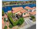 Aerial view of home with lake access, a large tile roof, and mature landscaping at 2708 Port Of Call Dr, Las Vegas, NV 89128