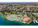 Beautiful aerial view of a lakefront pool and sandy beach community surrounded by lush landscaping at 2708 Port Of Call Dr, Las Vegas, NV 89128