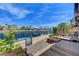Waterfront backyard features a patio, landscaping, stone pillar, and canal access, seamlessly blending architecture with natural beauty at 2708 Port Of Call Dr, Las Vegas, NV 89128