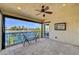 Covered balcony with ceiling fan overlooking canal view and seating area at 2708 Port Of Call Dr, Las Vegas, NV 89128