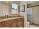 Elegant bathroom boasts granite counters, wooden cabinets and a glass enclosed walk-in shower at 2708 Port Of Call Dr, Las Vegas, NV 89128