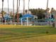 Community beach scene with palm trees, beach umbrellas and grassy area for residents at 2708 Port Of Call Dr, Las Vegas, NV 89128