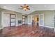Spacious bedroom with hardwood floors, ceiling fan, and custom closet organizers at 2708 Port Of Call Dr, Las Vegas, NV 89128