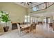 Dining room featuring high ceilings, travertine flooring, and a staircase with iron railings at 2708 Port Of Call Dr, Las Vegas, NV 89128
