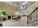 Bright and spacious dining room with high ceilings, tile flooring, and elegant staircase at 2708 Port Of Call Dr, Las Vegas, NV 89128