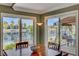 Inviting dining area boasts water views from large windows and sliding doors to the patio at 2708 Port Of Call Dr, Las Vegas, NV 89128