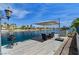 Outdoor patio seating area on a dock over the canal with a grill for entertaining at 2708 Port Of Call Dr, Las Vegas, NV 89128